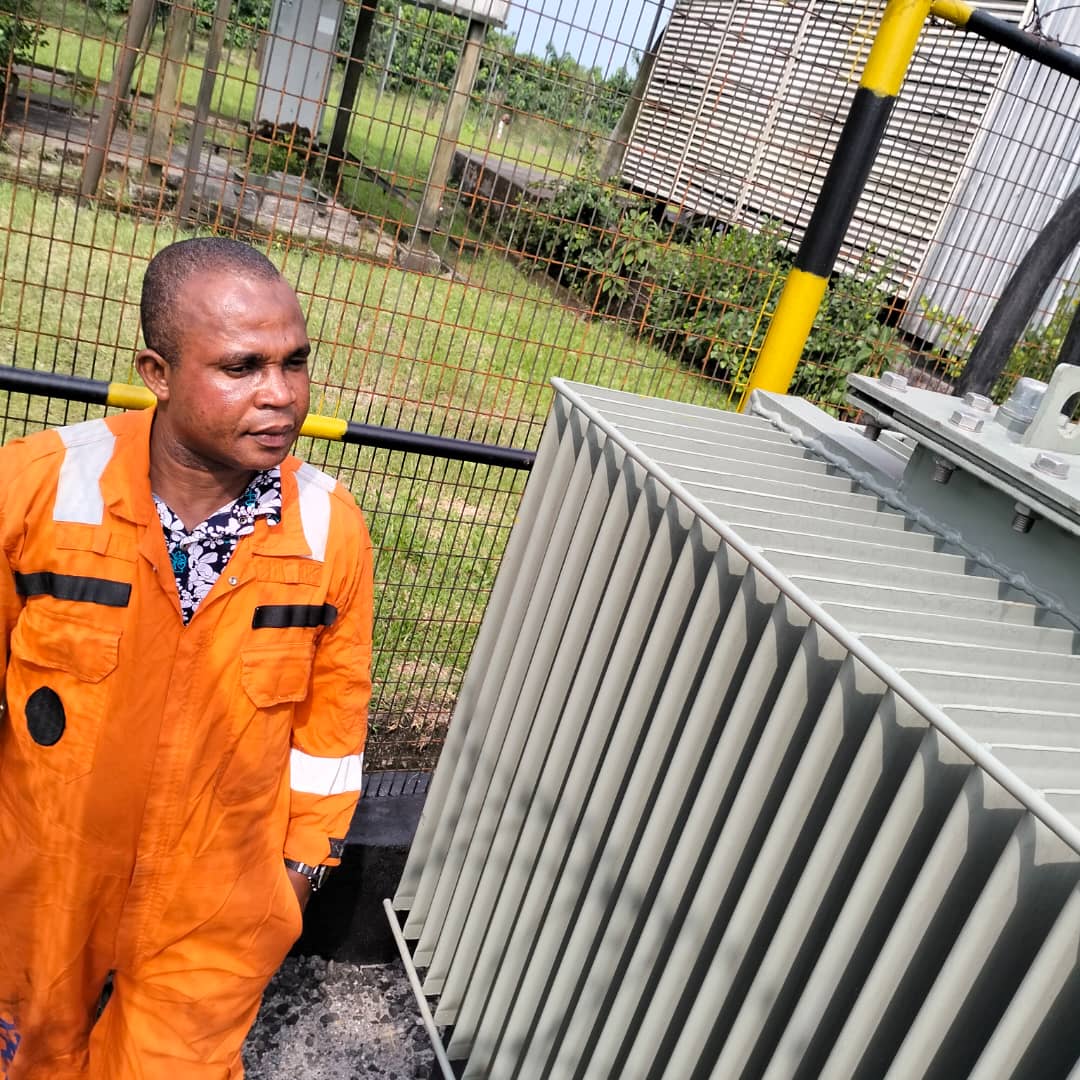 Engineer beside power transformer